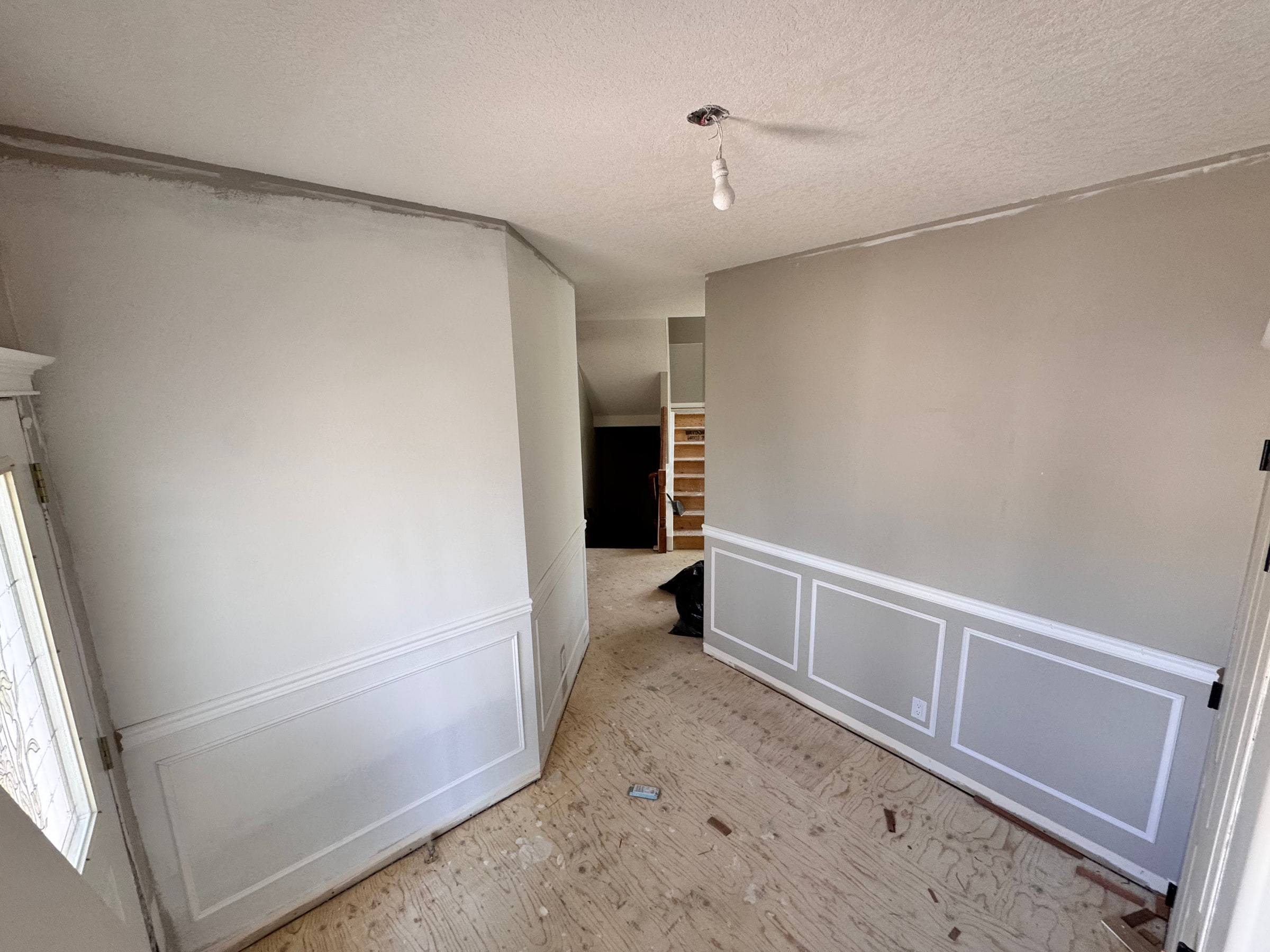 Wainscoting panels and chair rail running along a wall and around an outside corner