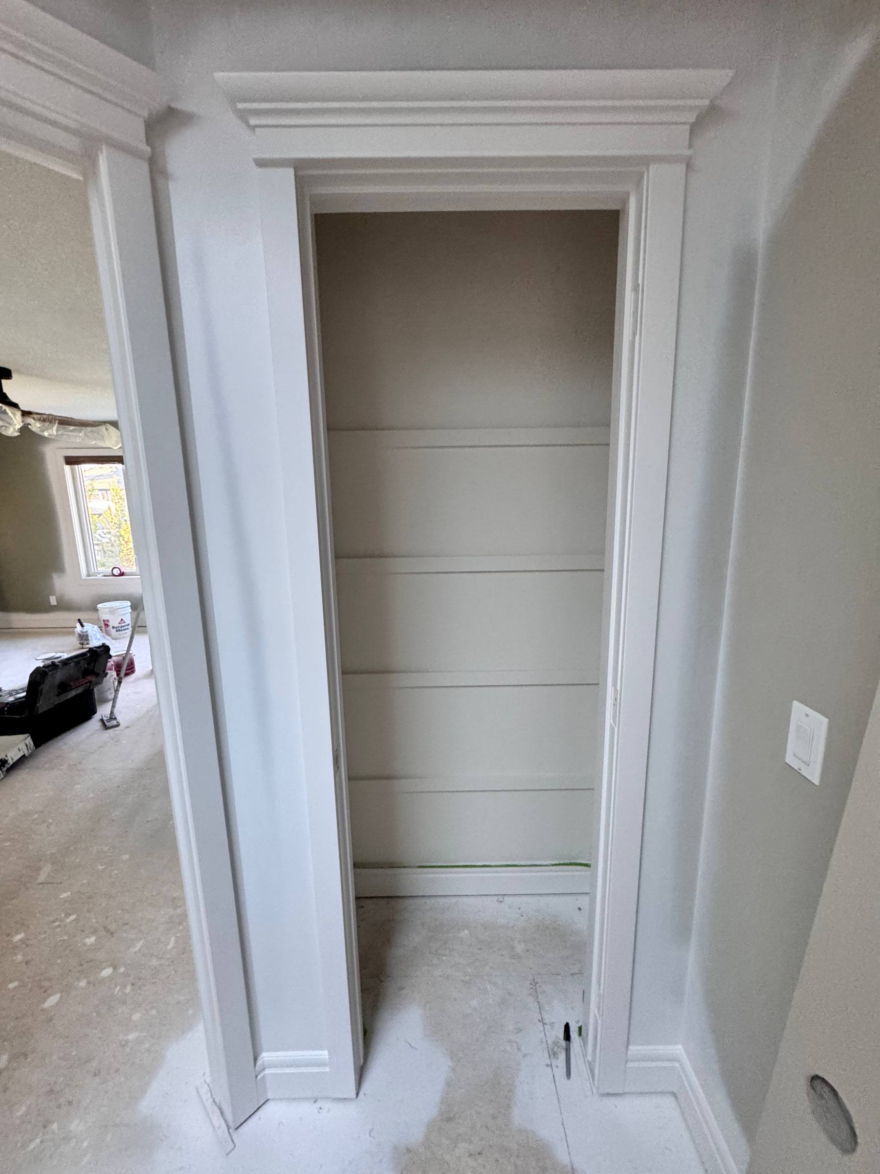 Closet opening with a new casing and header, baseboard returning into the opening